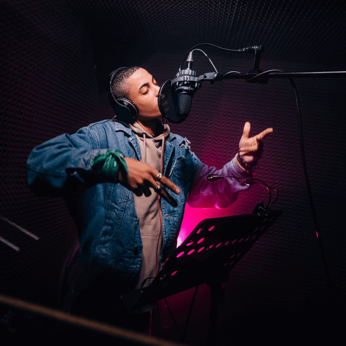 Artist singing in a booth.